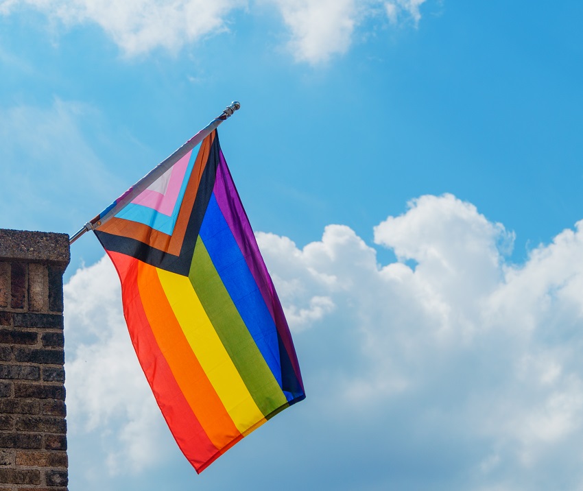 pride flag against a sunny sky